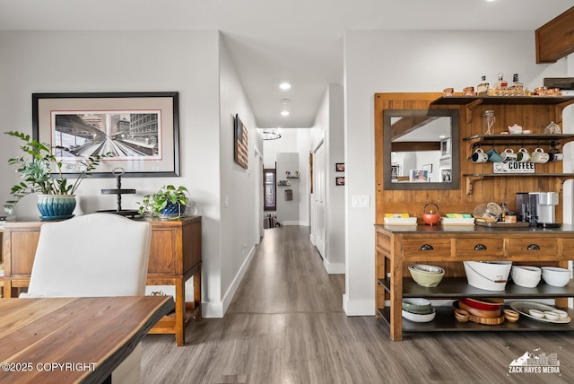 hallway featuring recessed lighting, wood finished floors, and baseboards