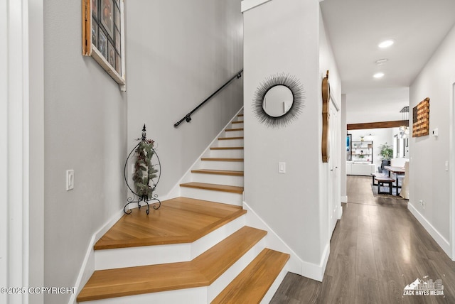 stairway with recessed lighting, wood finished floors, and baseboards