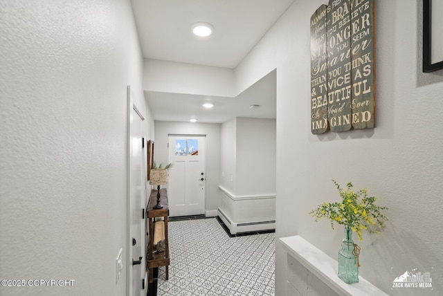 hallway with a baseboard heating unit