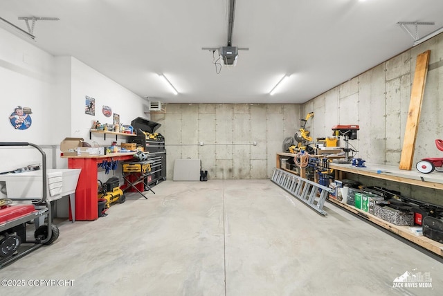 garage with a workshop area and a garage door opener