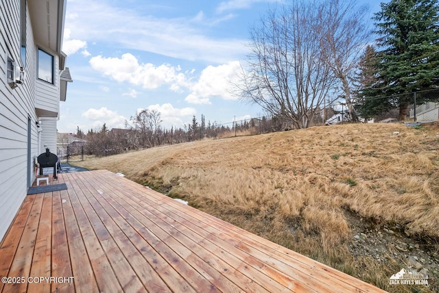 wooden terrace featuring fence