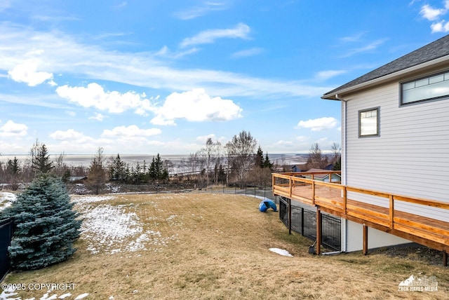 view of yard featuring a deck and fence