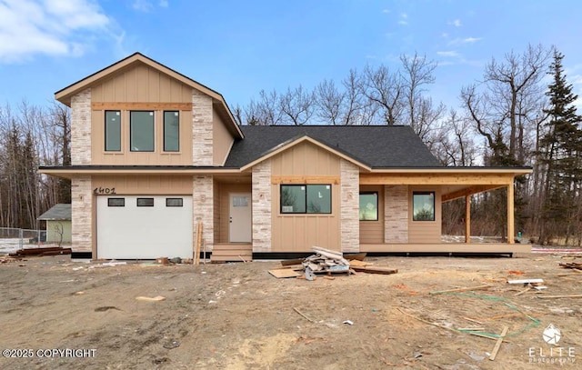 view of front of property with a garage, stone siding, aphalt driveway, and board and batten siding