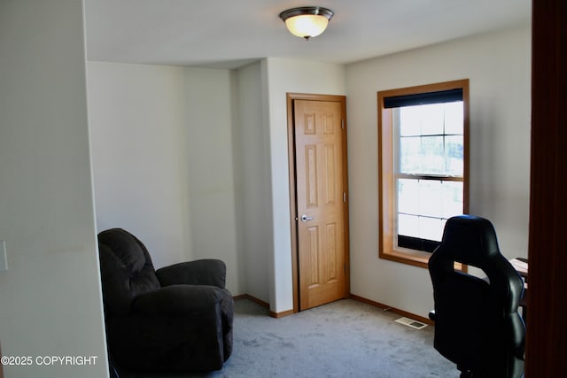 office area featuring light carpet, visible vents, and baseboards