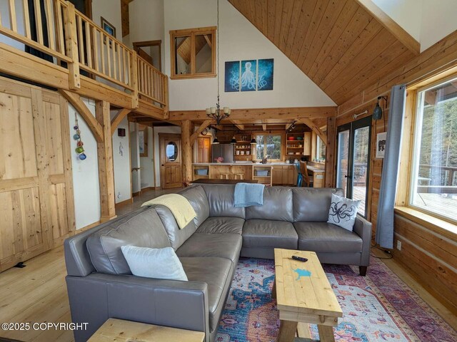 41650 Charlie Dr, Homer, AK 99603 - living area featuring wood finished floors, high vaulted ceiling, wood walls, and french doors