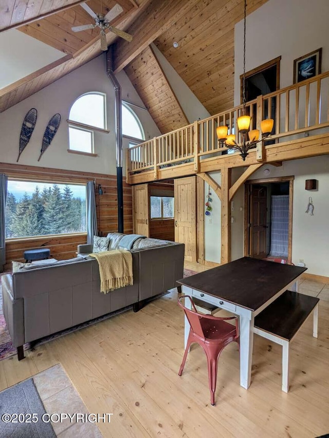 41650 Charlie Dr, Homer, AK 99603 - dining area featuring high vaulted ceiling, ceiling fan, a wooden ceiling with exposed beams, wood finished floors, and a chandelier