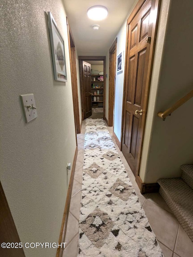 41650 Charlie Dr, Homer, AK 99603 - corridor with stairway, light tile patterned floors, and a textured wall