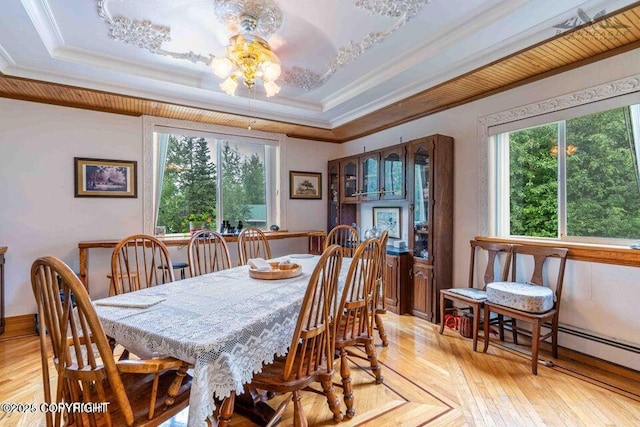 dining room featuring a tray ceiling, crown molding, and parquet flooring