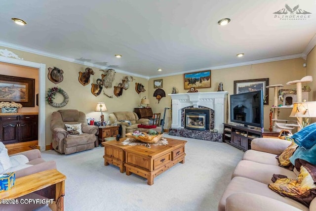 living room featuring recessed lighting, a premium fireplace, ornamental molding, and light colored carpet