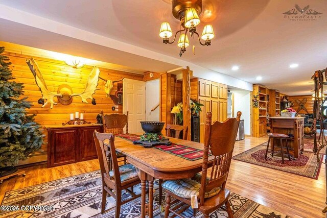 dining area featuring a chandelier, recessed lighting, and light wood finished floors