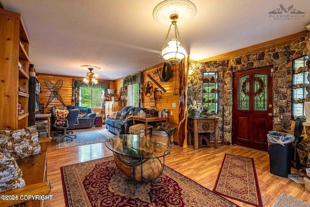 entryway with a notable chandelier and wood finished floors