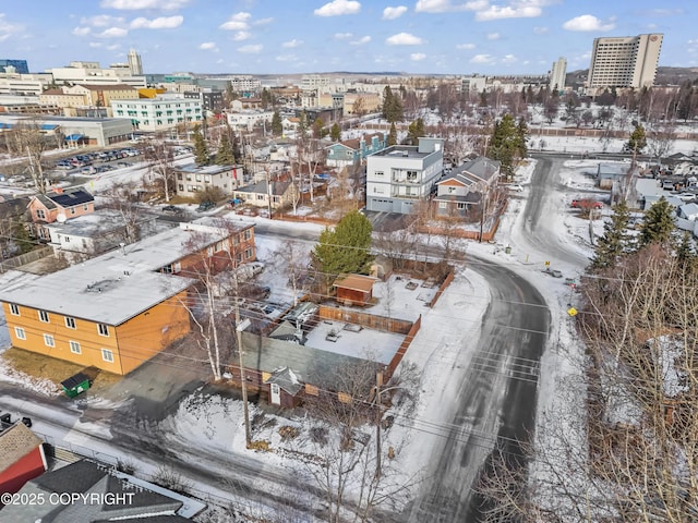 snowy aerial view featuring a view of city