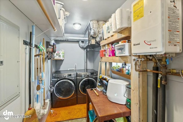 clothes washing area featuring water heater, laundry area, and independent washer and dryer