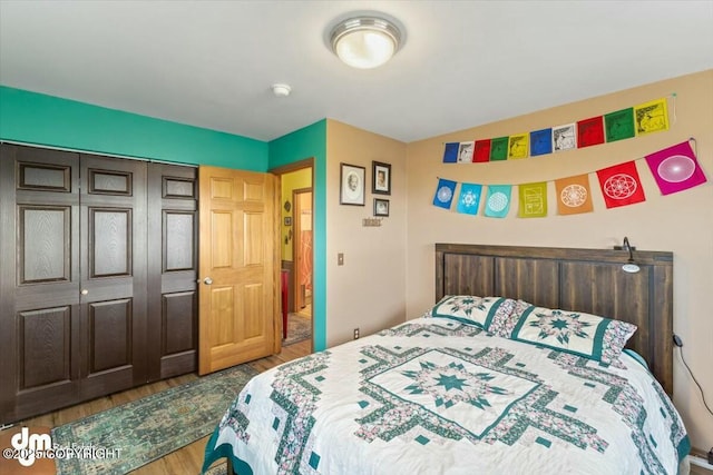 bedroom with a closet and wood finished floors