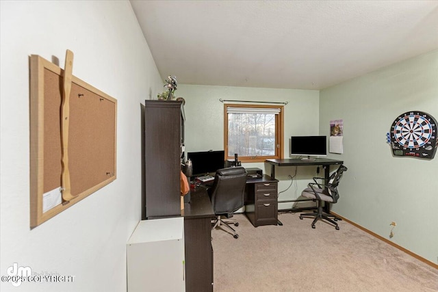 office space featuring light carpet and baseboards