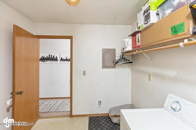 clothes washing area with washer / dryer, baseboards, electric panel, and laundry area