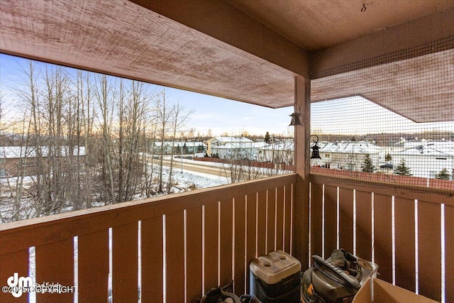 view of snow covered back of property