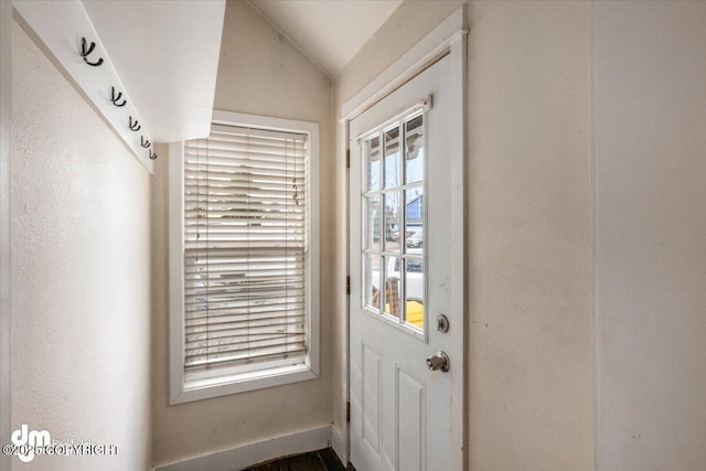 doorway to outside with vaulted ceiling