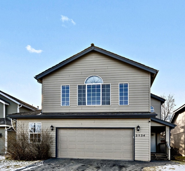 view of front of property featuring aphalt driveway and a garage