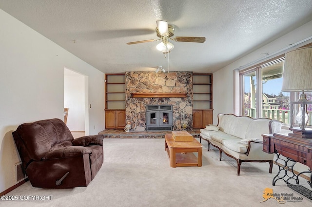 living room featuring a textured ceiling, a fireplace, visible vents, and light colored carpet