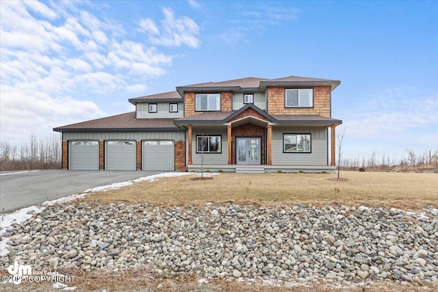 view of front of home featuring a front yard, french doors, driveway, and an attached garage