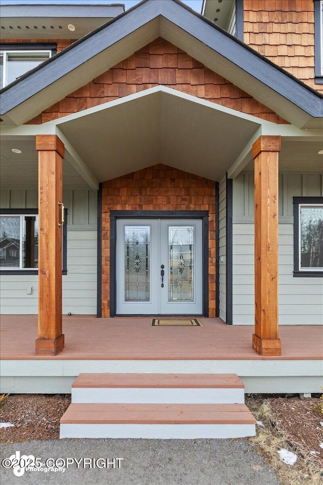 entrance to property with covered porch and french doors