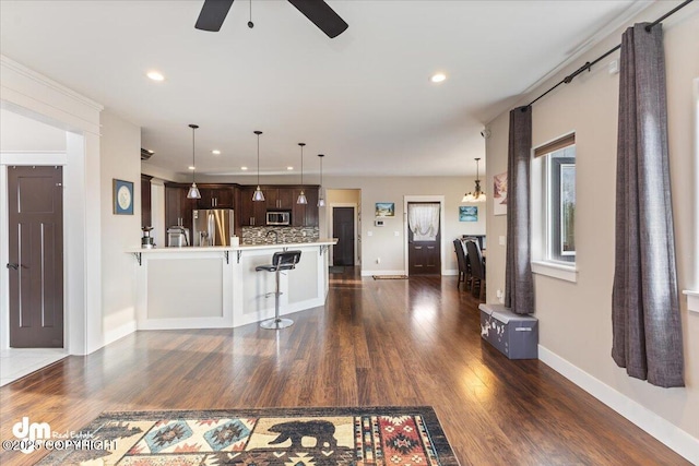 unfurnished living room featuring dark wood-style floors, recessed lighting, baseboards, and a ceiling fan