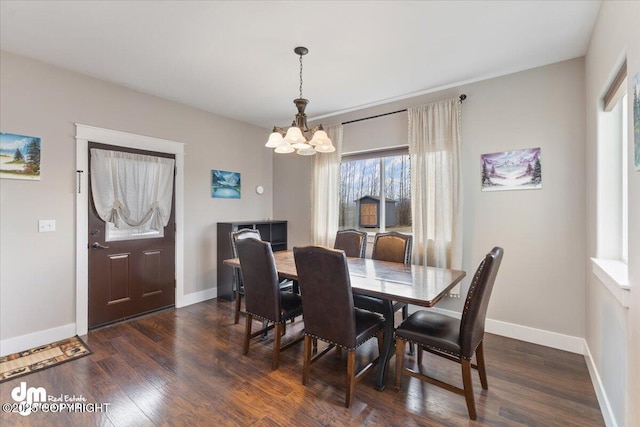 dining area with baseboards, a chandelier, and dark wood-type flooring