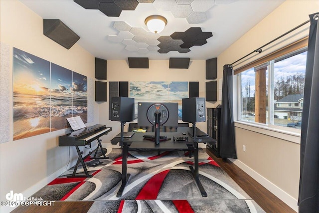 workout room featuring wood finished floors and baseboards