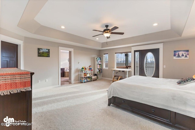 bedroom with baseboards, recessed lighting, a raised ceiling, and light colored carpet