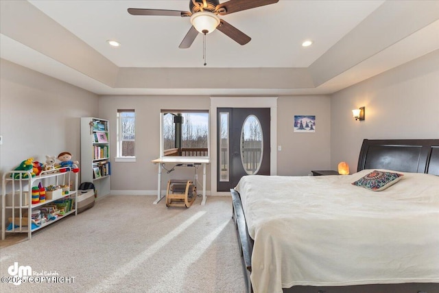 carpeted bedroom with access to outside, a raised ceiling, baseboards, and recessed lighting