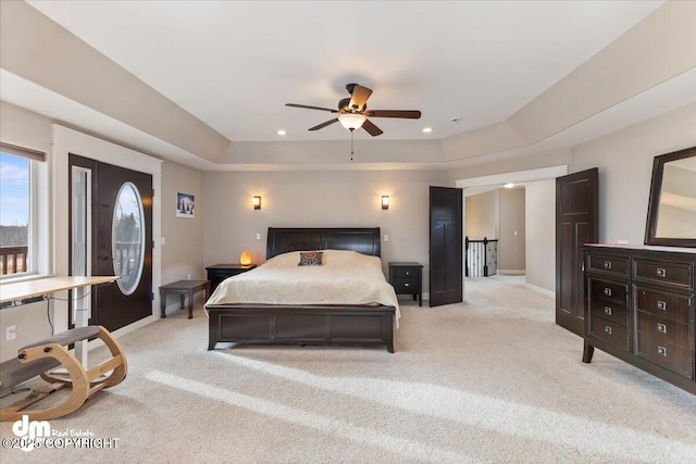 bedroom with recessed lighting, light colored carpet, a ceiling fan, baseboards, and a raised ceiling