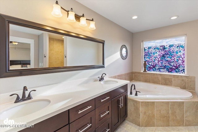 full bath with a garden tub, double vanity, a sink, and tile patterned floors