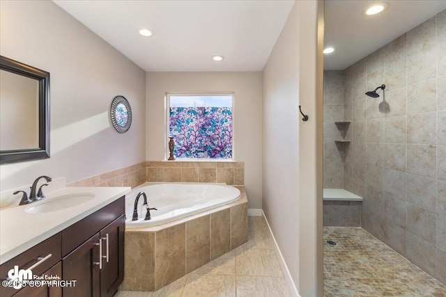 full bath with tile patterned floors, a tile shower, vanity, a bath, and recessed lighting