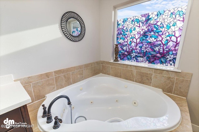 bathroom with a jetted tub and vanity