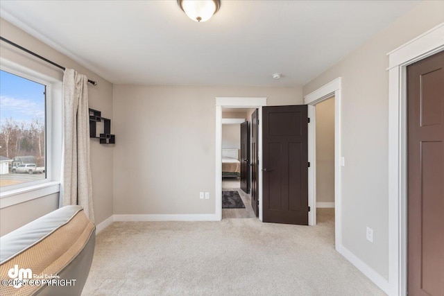 unfurnished bedroom featuring carpet and baseboards