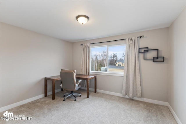 carpeted office space featuring baseboards