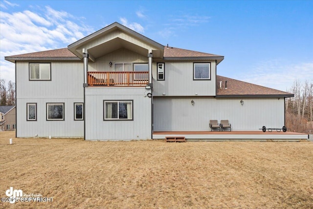 back of property featuring a balcony