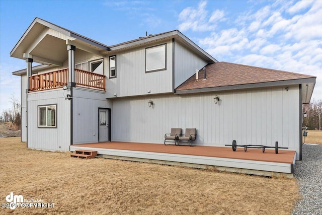 back of house with a balcony and a wooden deck