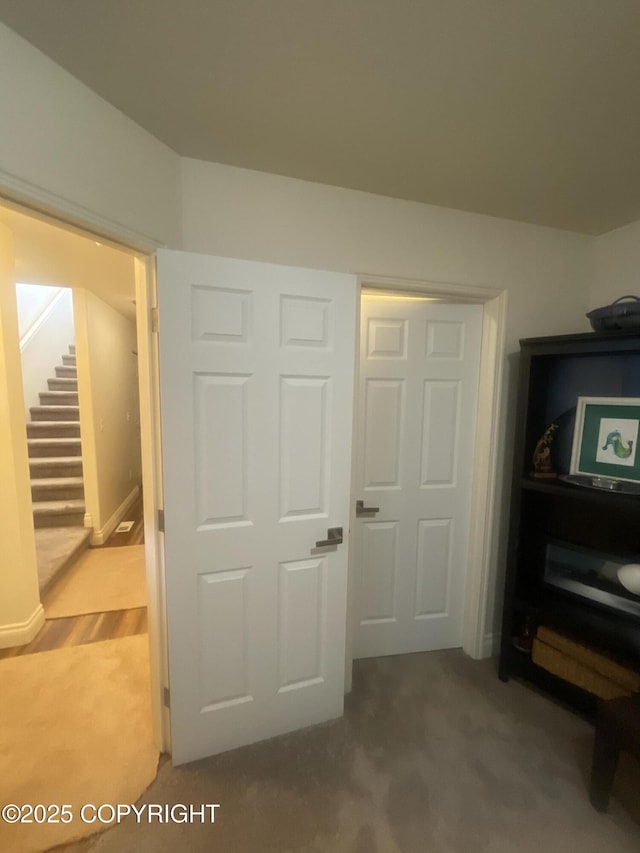 interior space featuring carpet and stairs