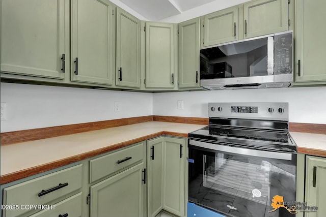 kitchen with appliances with stainless steel finishes, light countertops, and green cabinets