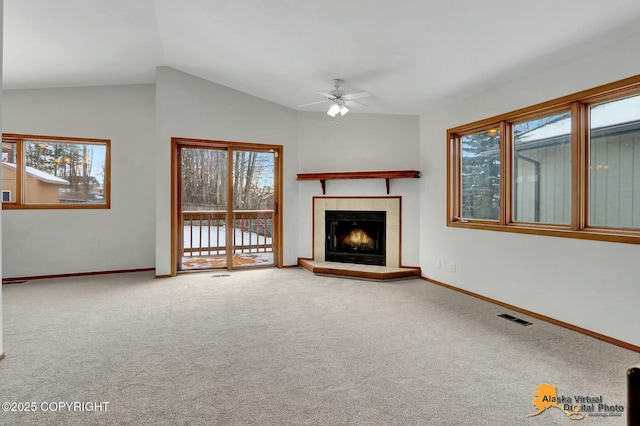 unfurnished living room featuring carpet floors, a fireplace, visible vents, and baseboards