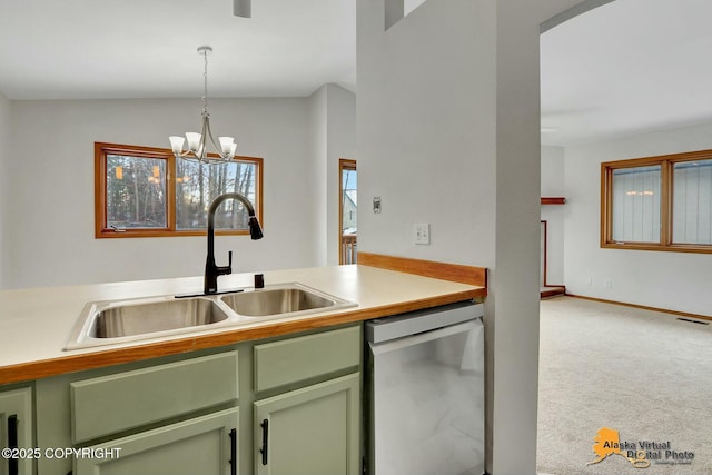 kitchen featuring carpet floors, a sink, light countertops, dishwasher, and pendant lighting