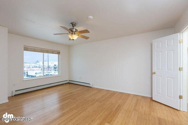 empty room with a ceiling fan, baseboards, light wood-style flooring, and baseboard heating