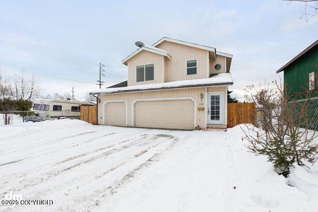 traditional-style house with an attached garage and fence