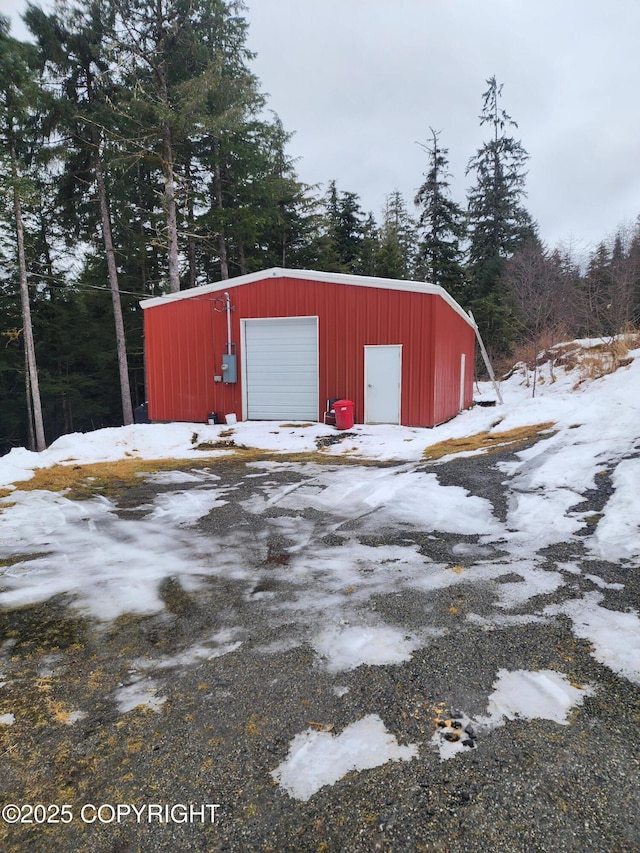 snow covered structure with an outdoor structure