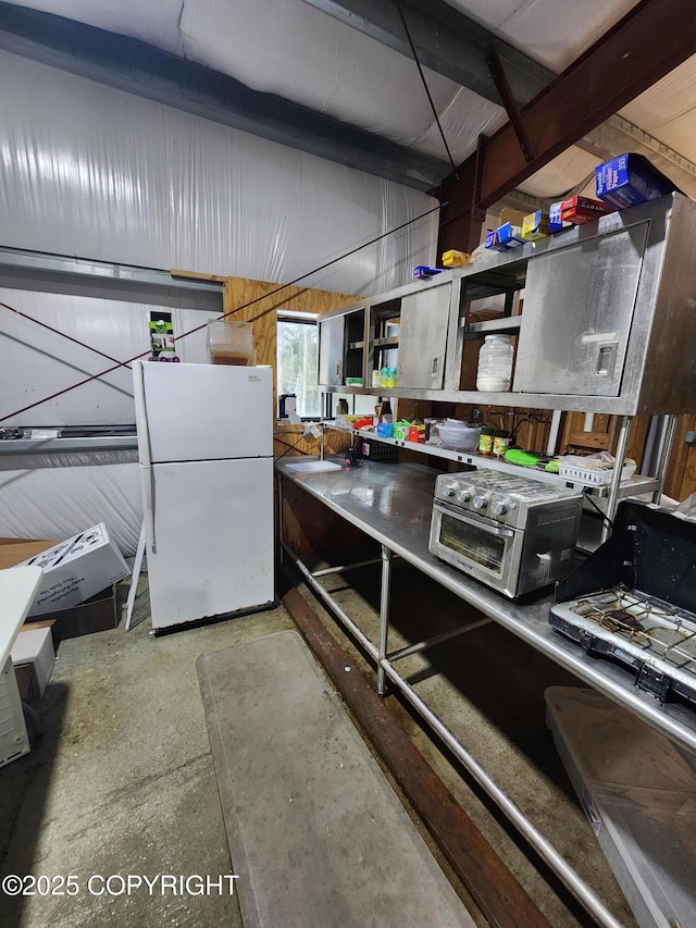 kitchen with freestanding refrigerator and a toaster