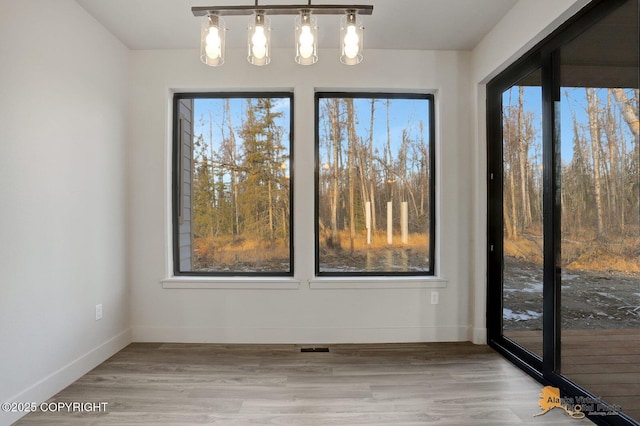 spare room featuring wood finished floors and baseboards