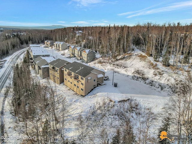 snowy aerial view with a residential view