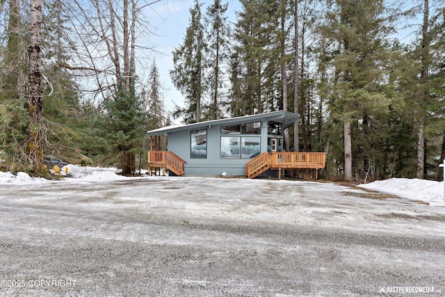 view of front of property with driveway and a deck